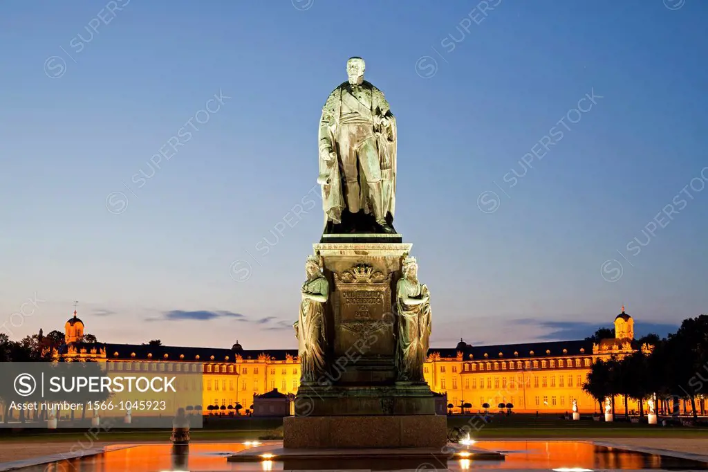 monument for Karl Friedrich von Baden in front of the illuminated Karlsruhe Palace, Karlsruhe, Baden-Württemberg, Germany