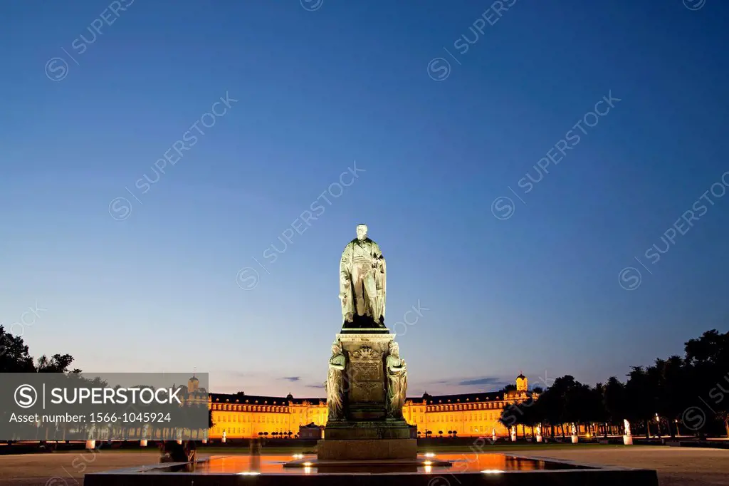 monument for Karl Friedrich von Baden in front of the illuminated Karlsruhe Palace, Karlsruhe, Baden-Württemberg, Germany