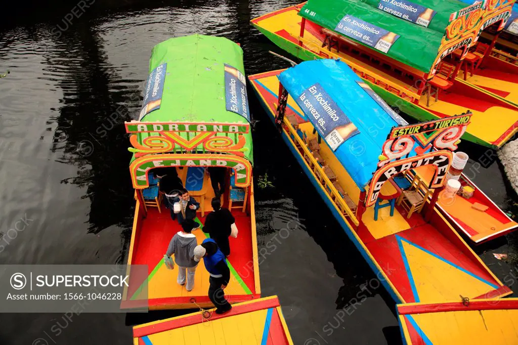 Trajineras boats waiting for customers in the water of Floating Gardens of Xochimilco  Xochimilco  Mexico.