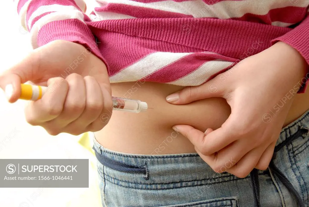 Insulin injection  Diabetic woman injecting herself in the abdomen with insulin