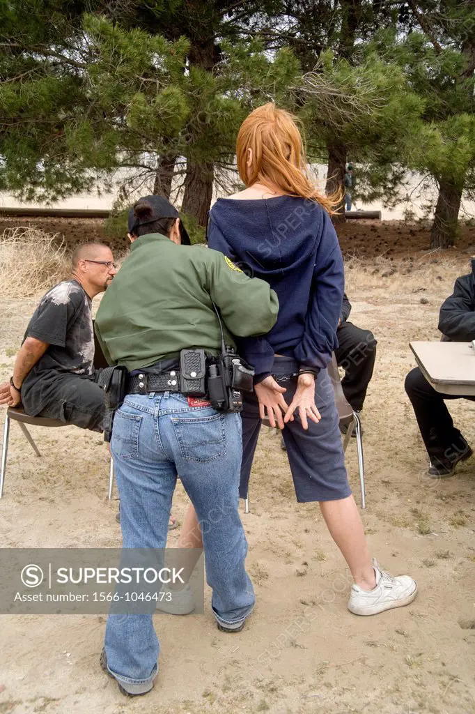 Sherriff´s deputies arrest a homeless woman on an outstanding warrant in Victorville, CA, during the search of an homeless encampment in the Southern ...