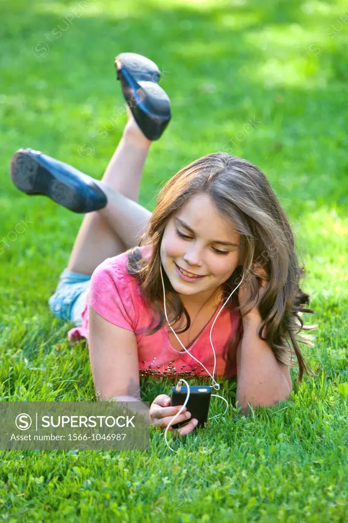 Young girl outdoors listening to music