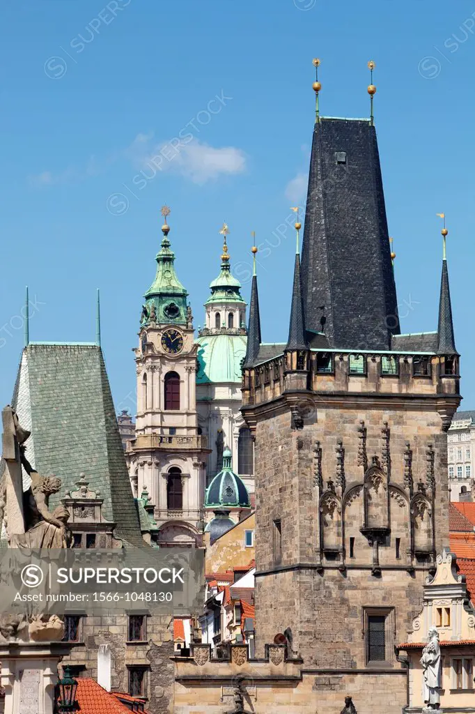 prague - different architectural styles-st  nicolas church and charles bridge tower