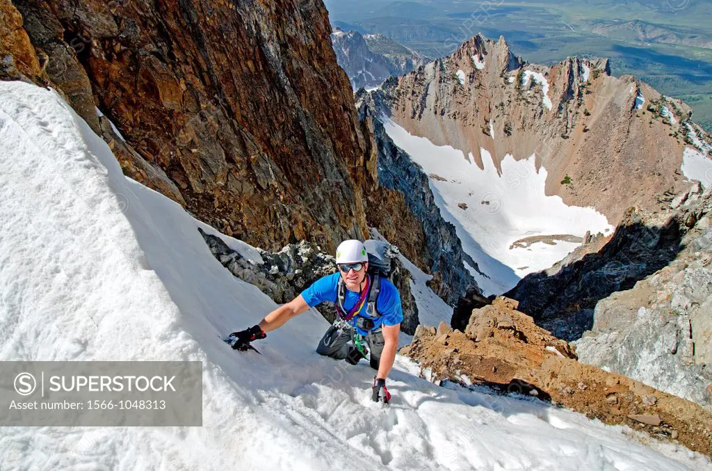 climbing The June Couloir on the North Face of Williams Peak high above the Sawtooth Valley in the Sawtooth Mountains near the town of Stanley in cent...