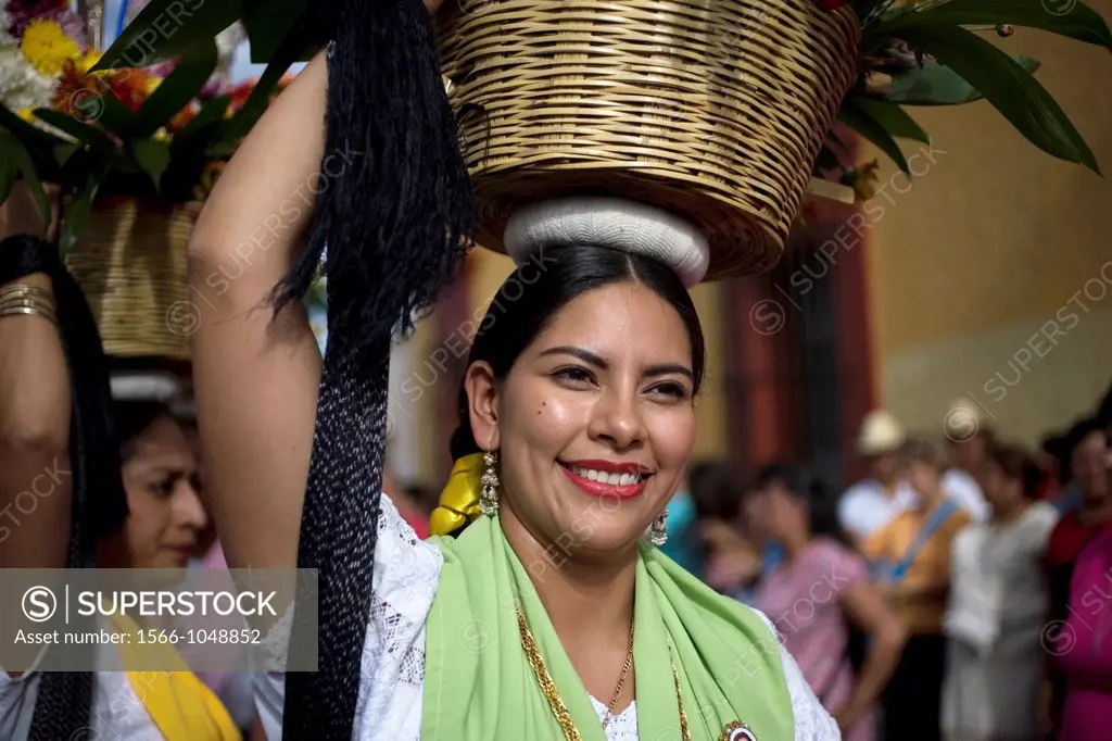 A ´china oaxaquena´ dances balancing a basket of flowers on her head in during the Guelaguetza parade in Oaxaca, Mexico, July 21, 2012  Oaxaca commemo...