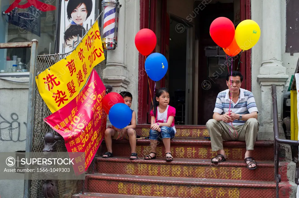 Stoop siting in Chinatown on Eldridge Street during the ´Egg Rolls and Egg Creams´ street fair in New York The popular fairs celebrates the diversity ...