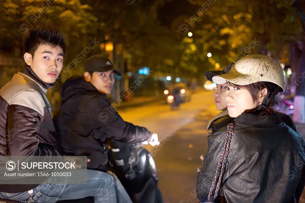 Modern youth on scooters on the streets of Vietnam at night