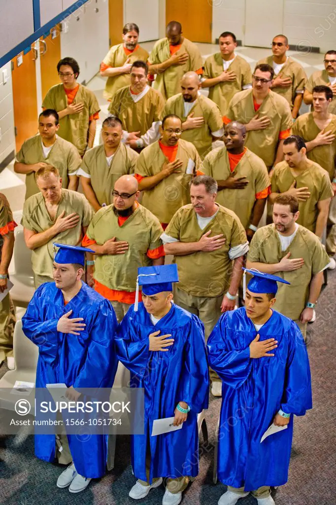 Wearing academic caps and gowns, three inmates are joined by their fellow multiracial prisoners in the city jail in Santa Ana, CA, as they recite the ...