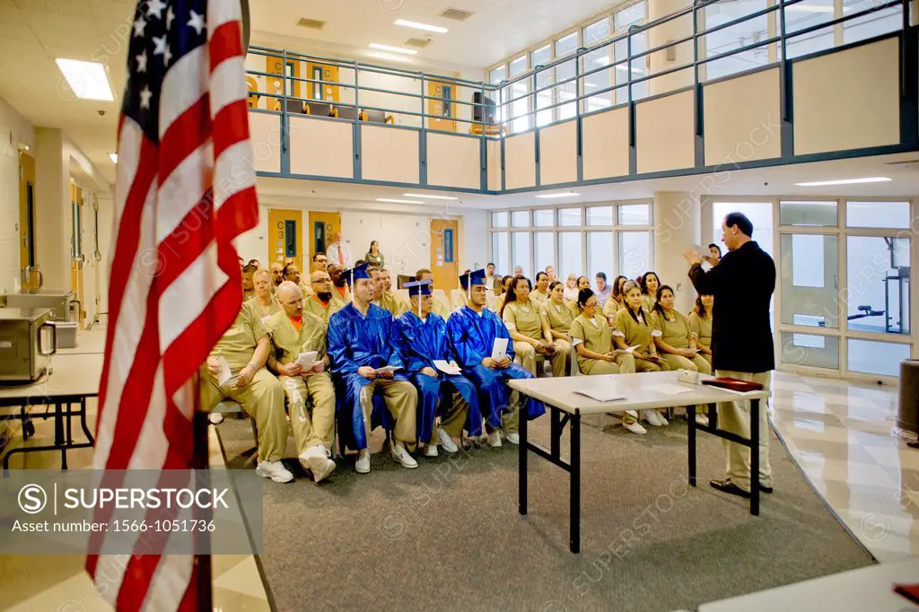 Wearing academic caps and gowns, three inmates are joined by their fellow multiracial prisoners in the city jail in Santa Ana, CA, for a graduation ce...