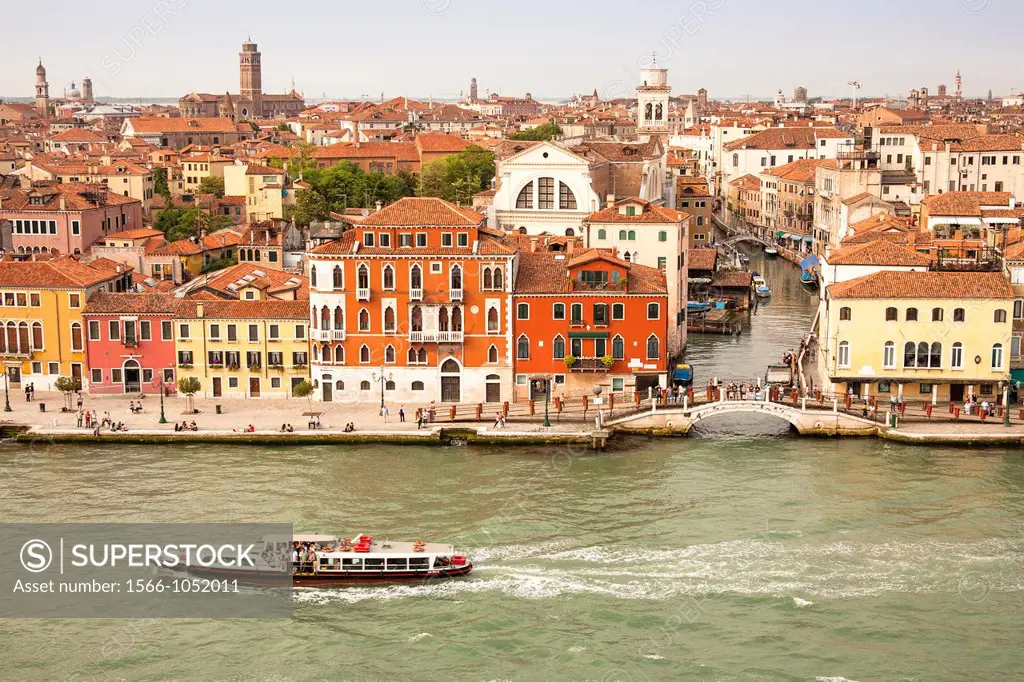 Panoramic view of buildings, rooftops, promenade and Giudecca Canal, Venice, Italy