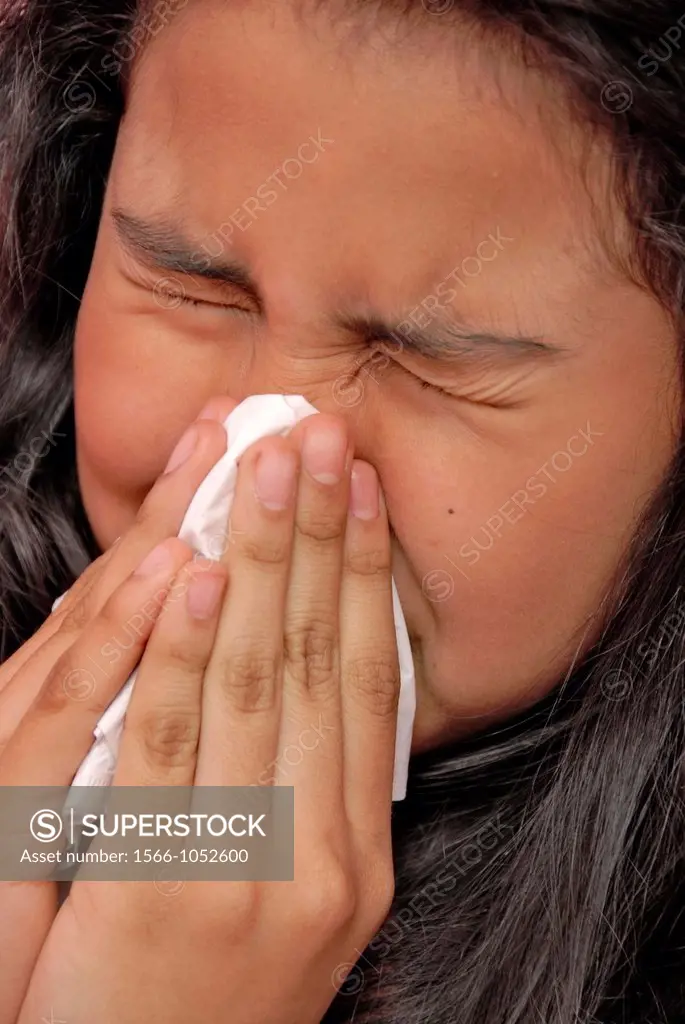 12 years old girl blowing her nose