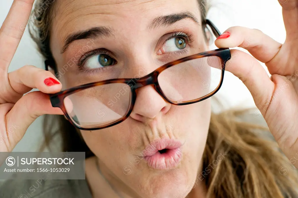 Woman looking over glasses