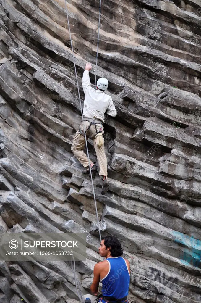 near Boquete Panama: a foreign tourist climbing a rock