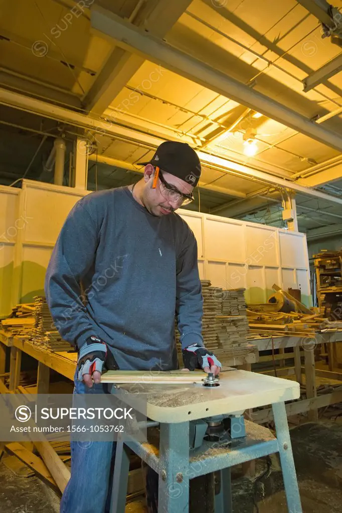 Detroit, Michigan - Workers clean lumber and prepare it for re-use at a warehouse operated by the nonprofit WARM Training Center  The lumber was salva...