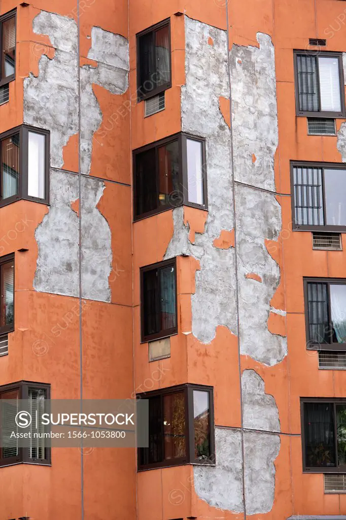 Peeling paint and a damaged facade on an apartment building in the New York borough of the Bronx