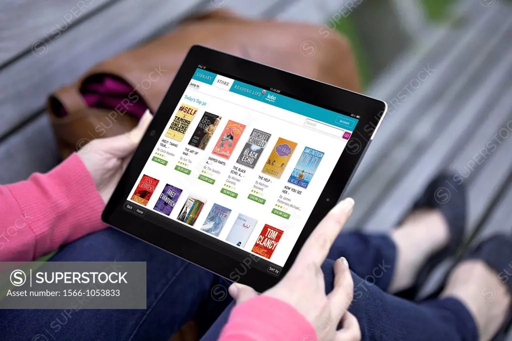 Close up view of a woman browsing Kobo online book store app on an iPad 2