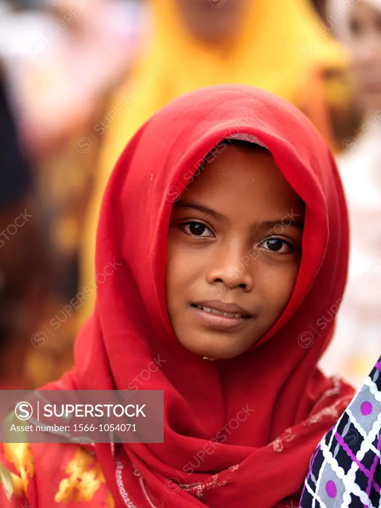 Portrait of a young girl wearing a bright red traditional Muslim Hijab in Johor, Malaysia