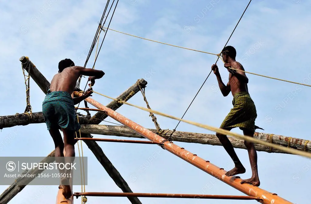 Indian men working with chinese fishing nets in Kochi,Kerala,South India,India,Asia