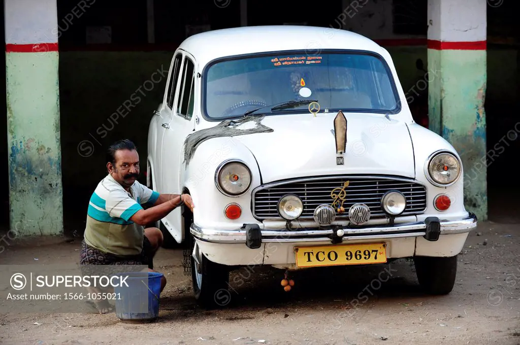 Man washing Ambasssador car in Tanjore,South India,Asia