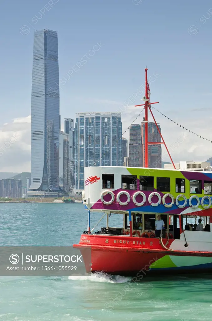 A Star Ferry in Victoria Harbour with the Hong Kong waterfront development of Union Square in the background, Hong Kong, China