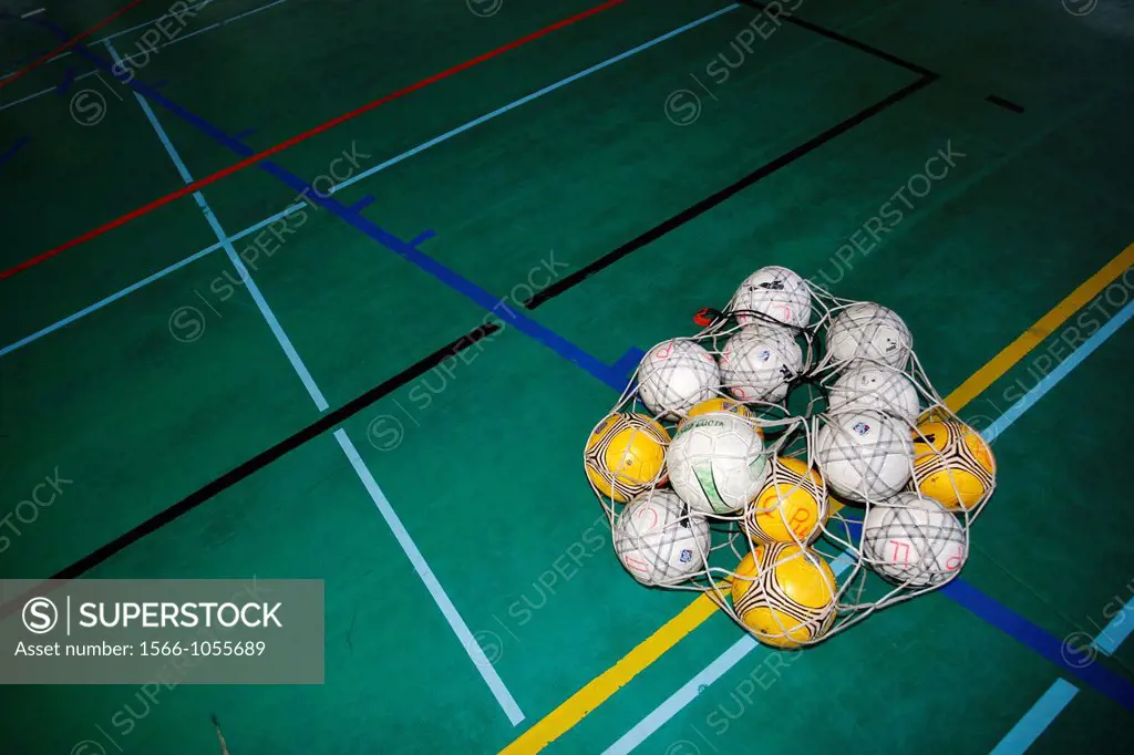 Footballs in container