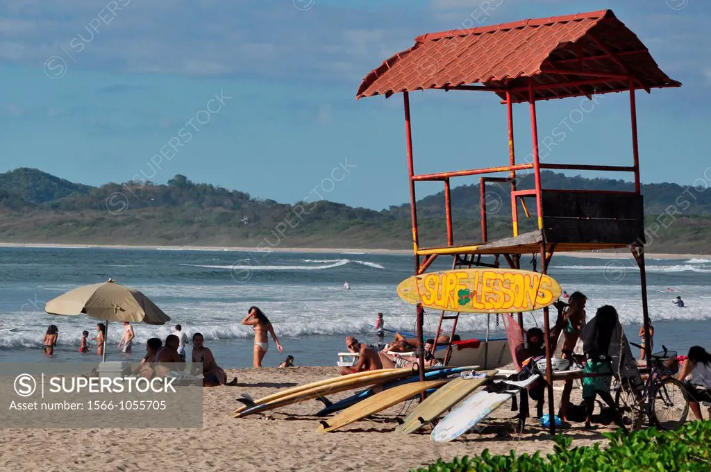 Playa Tamarindo Costa Rica: surf boards and tourists at the beach  