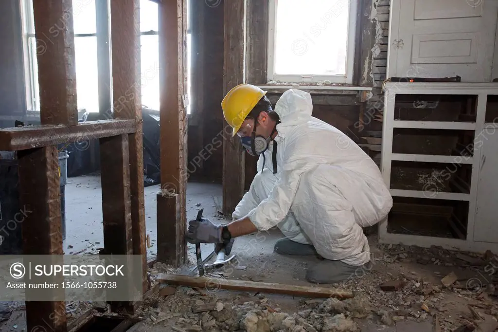 Detroit, Michigan - Workers salvage building materials from a home being ´deconstructed ´ Deconstruction, an alternative to standard demolition, takes...