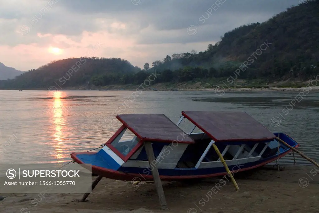River boat being repaired at sunset, Mekong River, Luang Prabang, Laos