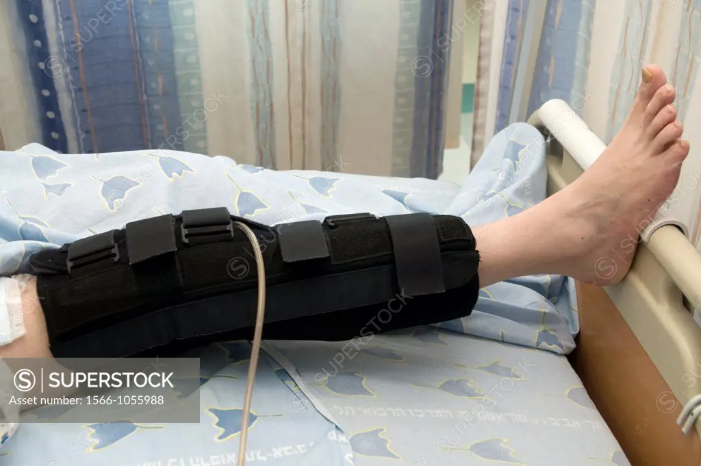 Male patient in hospital bed with a knee immobilizer
