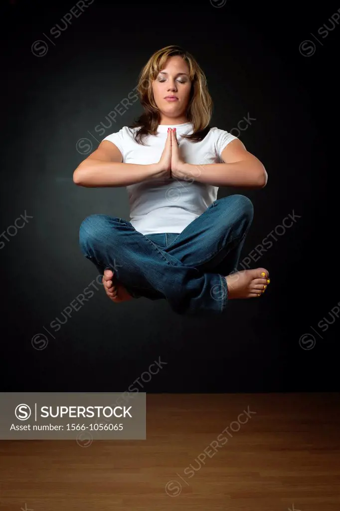 Woman meditating while floating in air