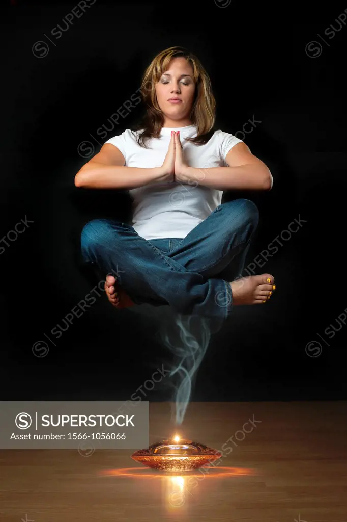 Genie levitation - woman floating in air over smoking oil lamp