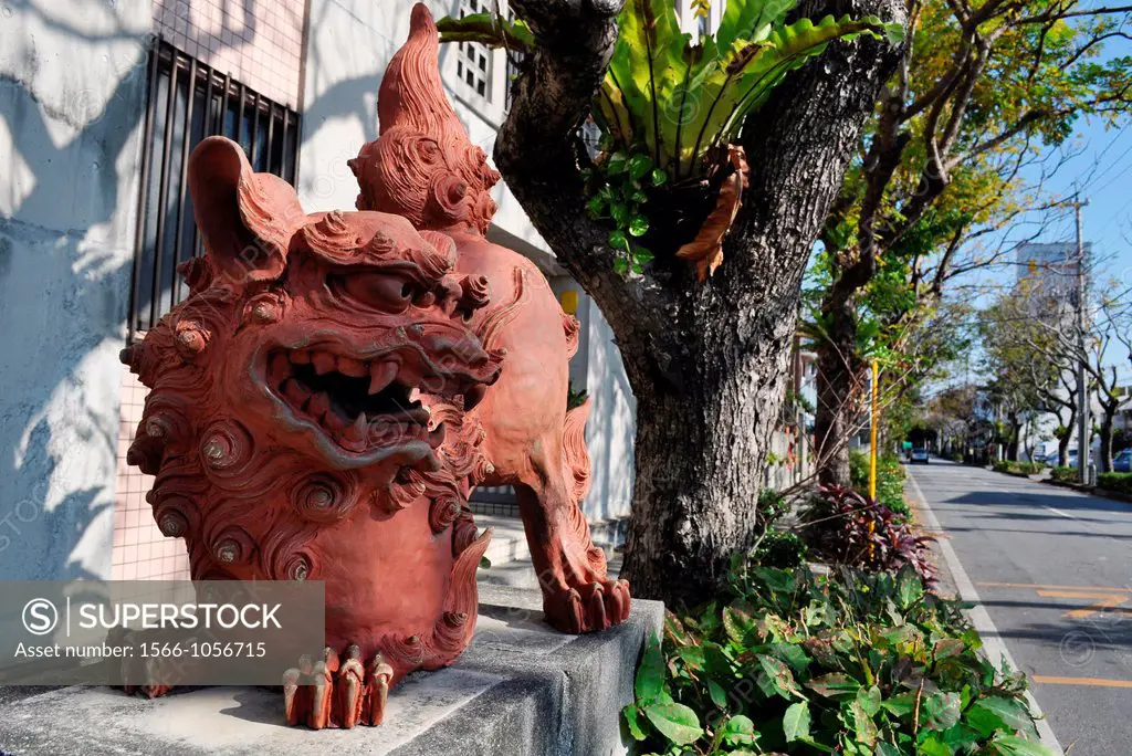 Naha Japan: Shisa statuette, guarding the entrance of a street  Shisa is a traditional Ryukyuan decoration, often in pairs, resembling a cross between...