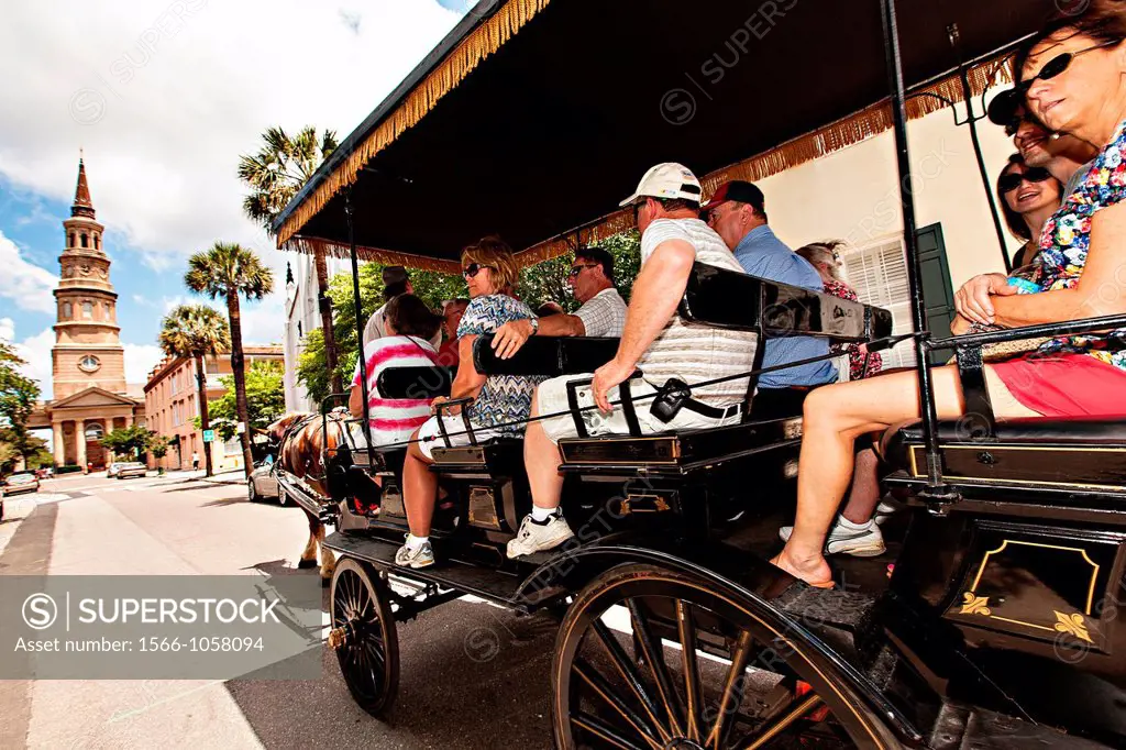 A horse drawn carriage takes tourists down historic Church Street to St  Philips Church in Charleston, South Carolina