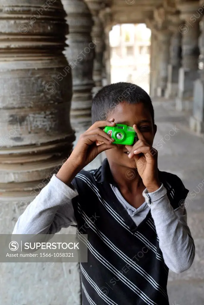 Portrait of boy making photo in temple of Belur,Karnataka,South India,India,Asia