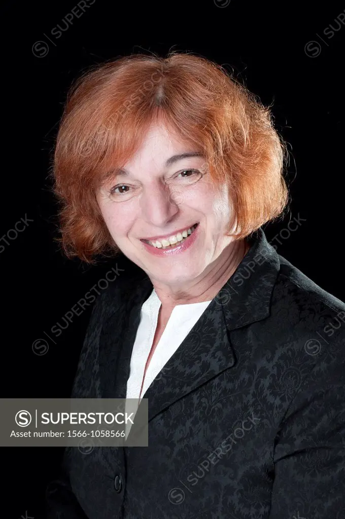 Middle aged woman with red hair looking happy