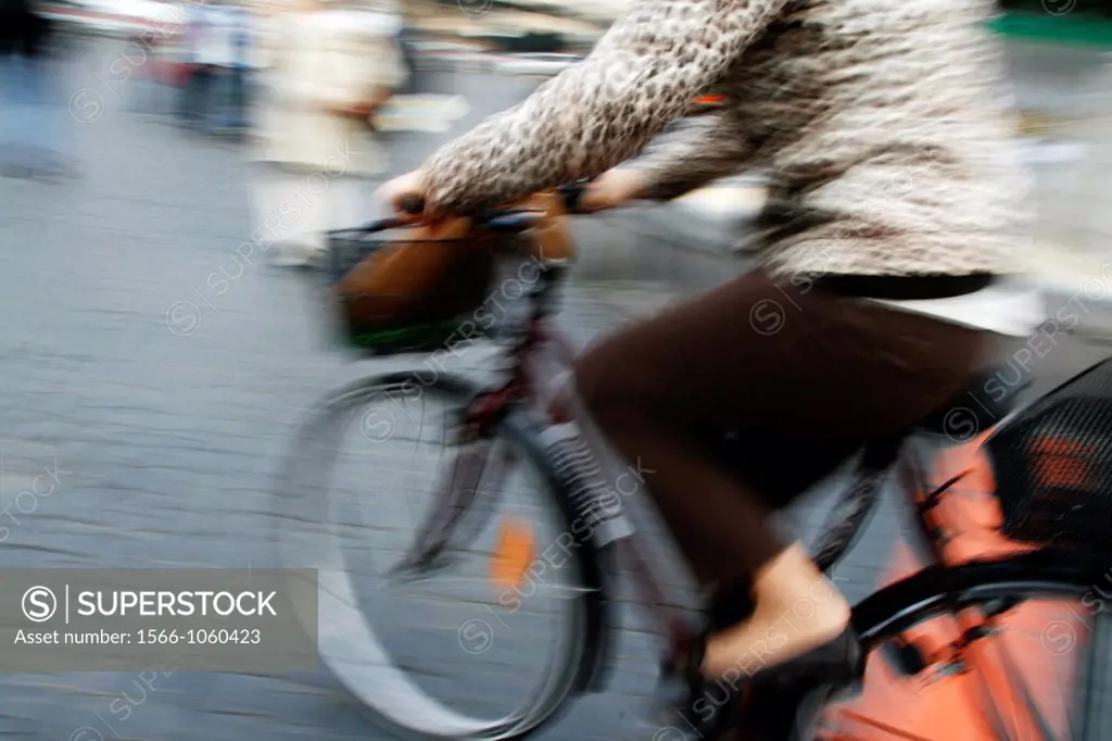 woman on bike with shopping basket in rome italy