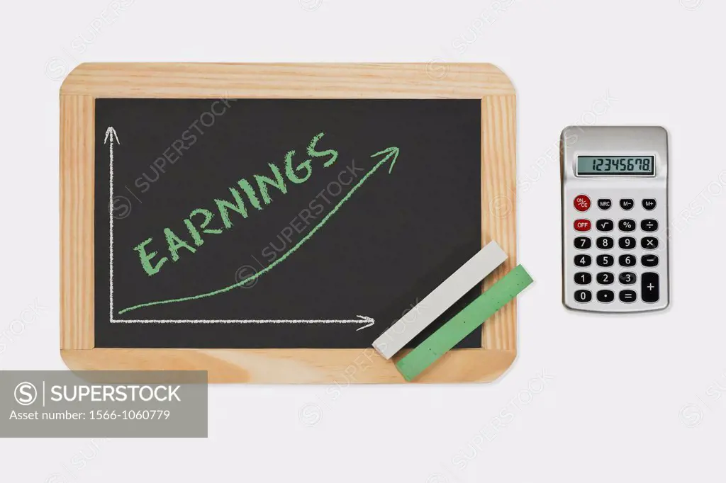 Detail photo of a chalkboard. A chart with an increasing curve on this. On the chalkboard is the word Earnings written. Green and white chalk lies in ...