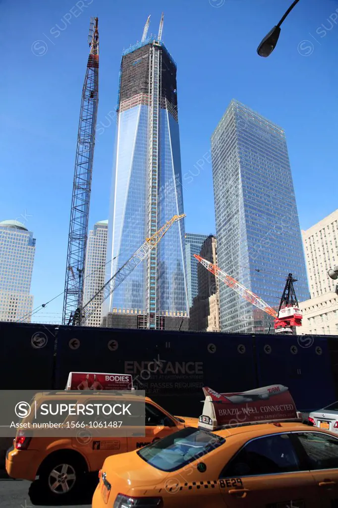 One World Trade Center formerly known as the Freedom Tower under construction in the new World Trade Center complex in Lower Manhattan with yellow cab...