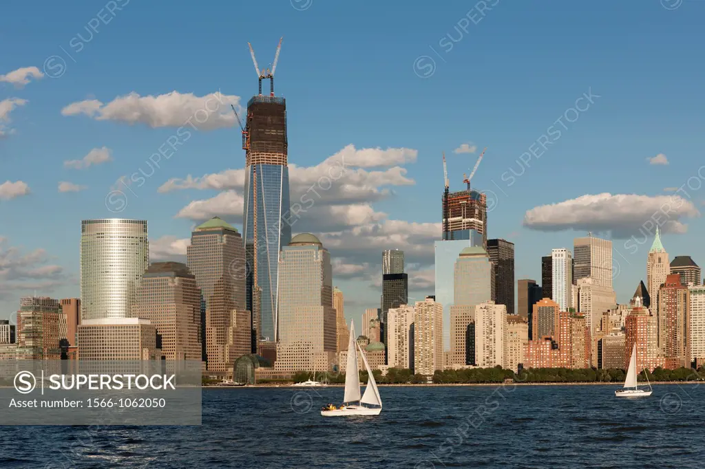 Sailboats catch the breeze on the Hudson River in New York City late on a summer afternoon, with the buildings of the World Financial Center and the W...
