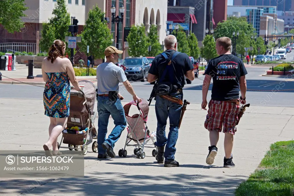 Lansing, Michigan - Gun rights advocates, many of them carrying firearms, leave the state capitol after a rally opposing a bill to repeal the Michigan...