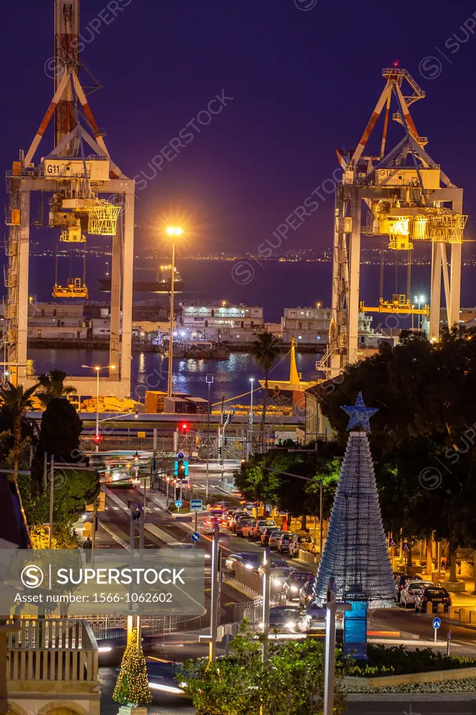 Shipping container cranes illuminated at night in Haifa´s port
