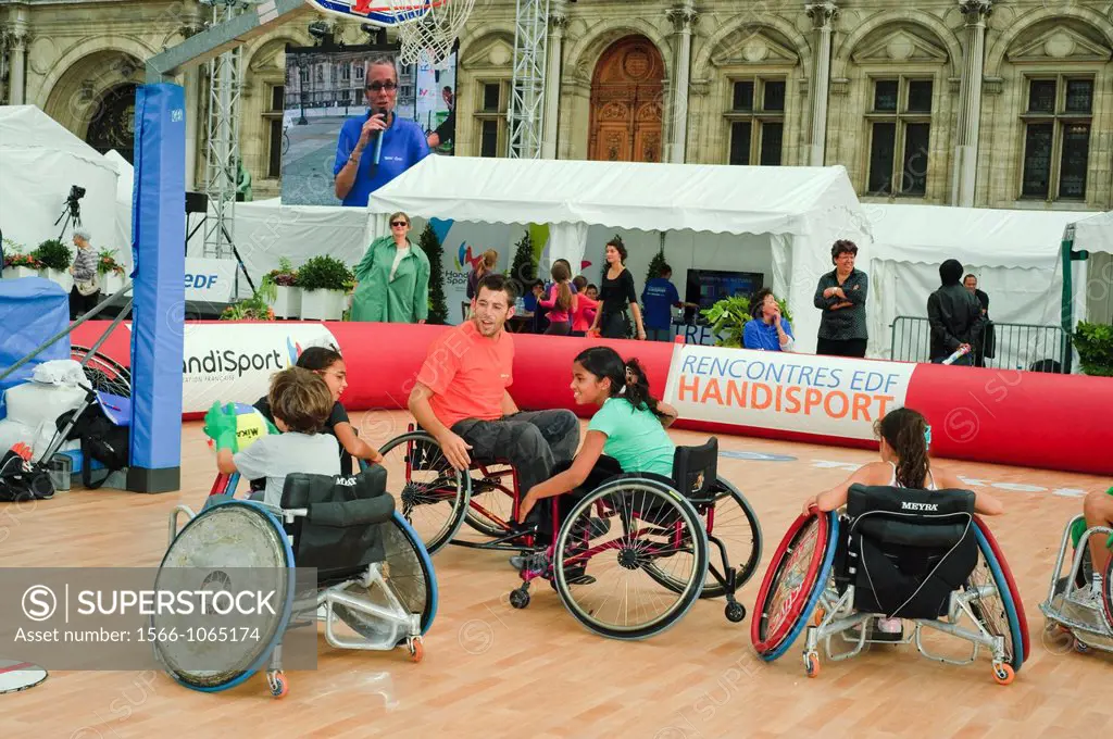 Paris, FRANCE - French Handicapped Athletes Teaching Children in Physical Fitness Class at ´Rencontres EDF Handisport´ Man and Children in Wheelchairs...