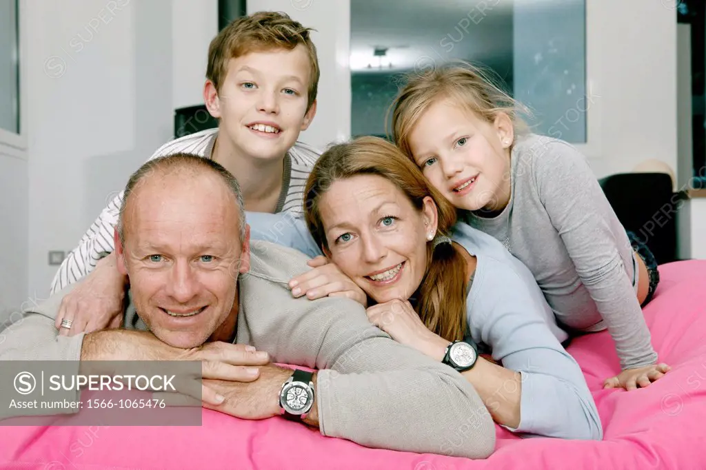 Portrait of happy family looking at camera