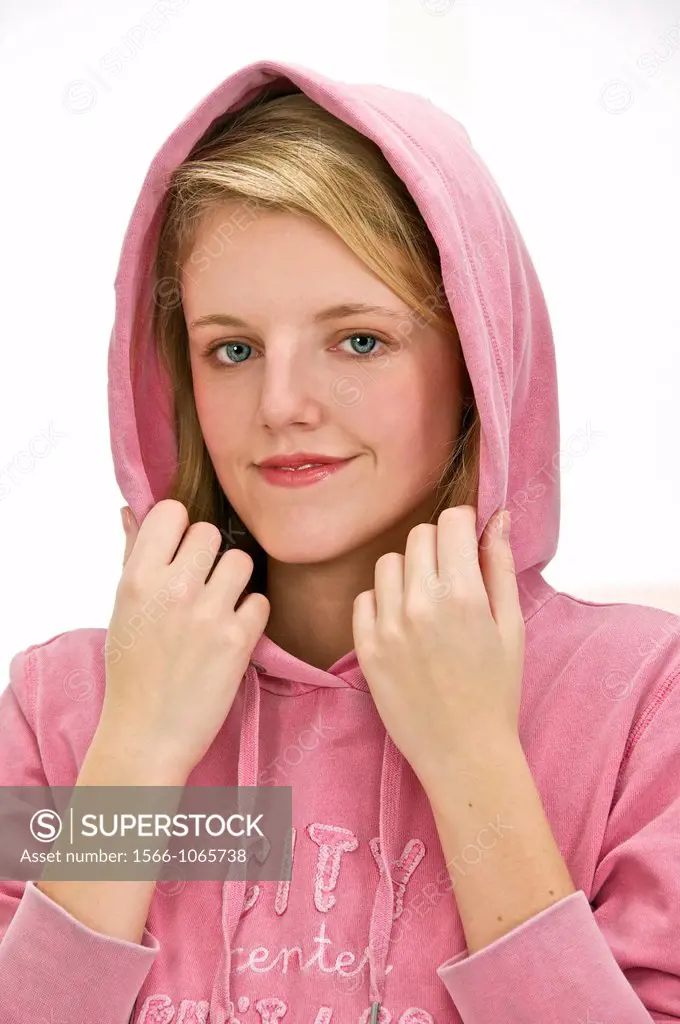 young pretty blond woman holding the hood of her pink jogging over her head to protect herself from the cold