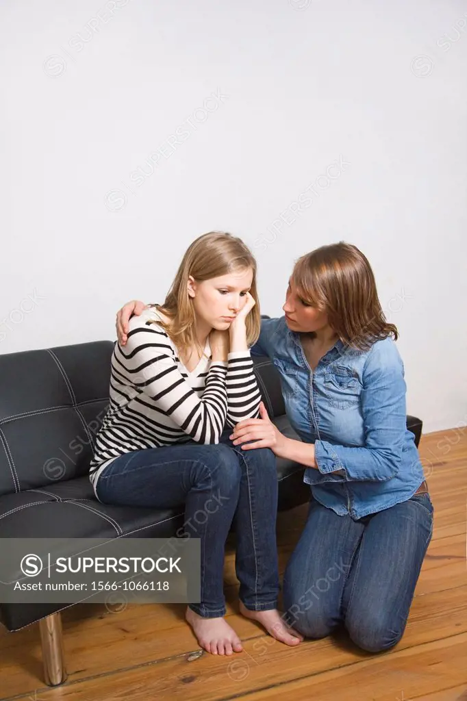 Woman consolating her friend at home