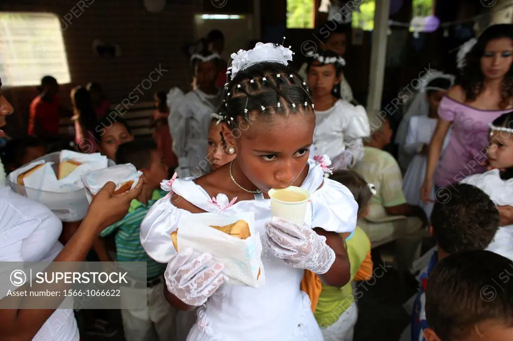Children celebrate their first commune in the local slum church