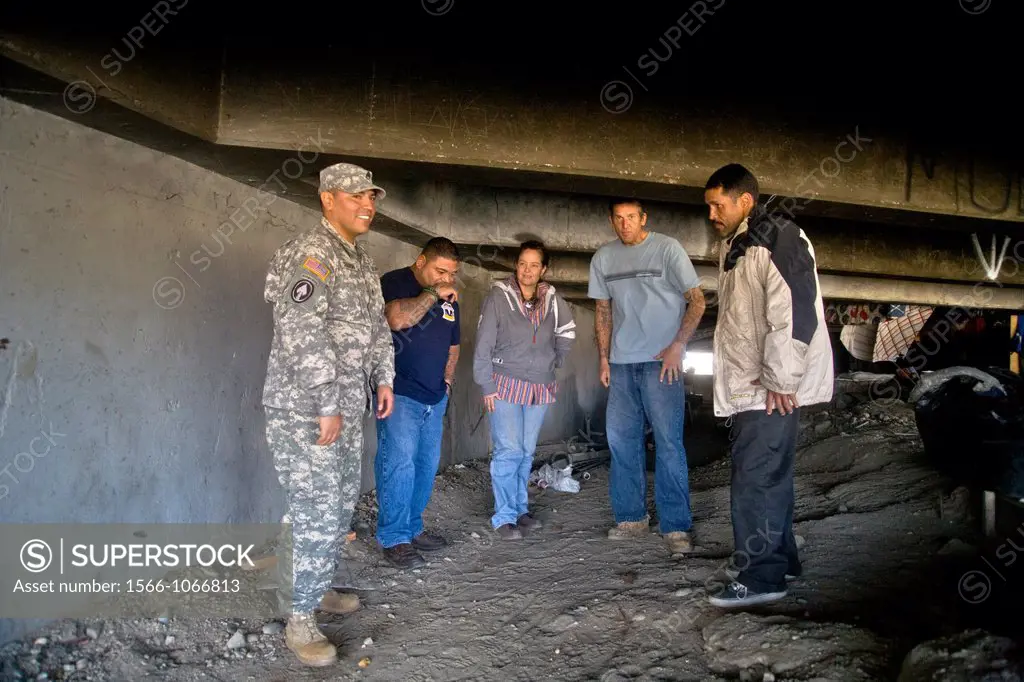An official of the charitable outreach program Vet Hunters greets homeless military veterans living under a Southern California bridge  Supported by t...
