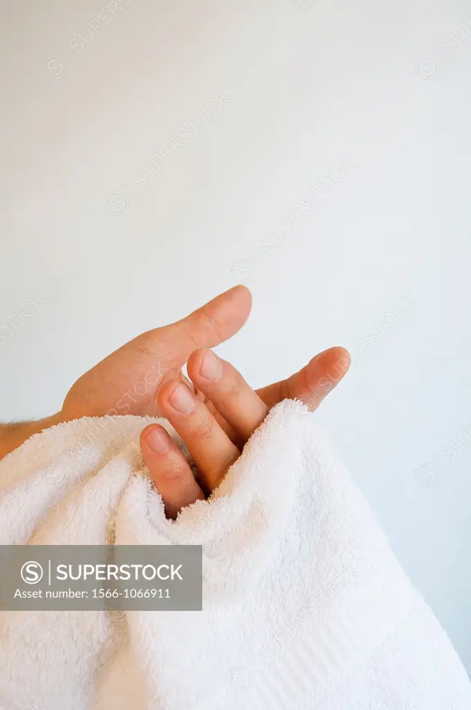 Man drying his hands with the towels. Close view.