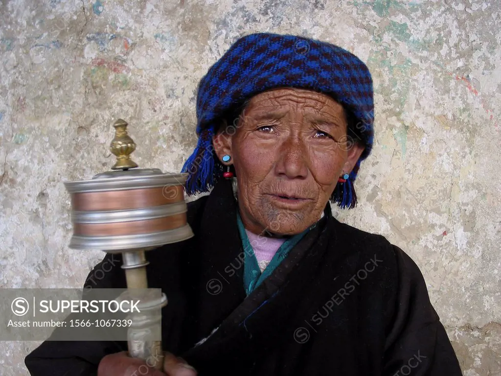 A woman with praying wheel in Lhasa, Tibet