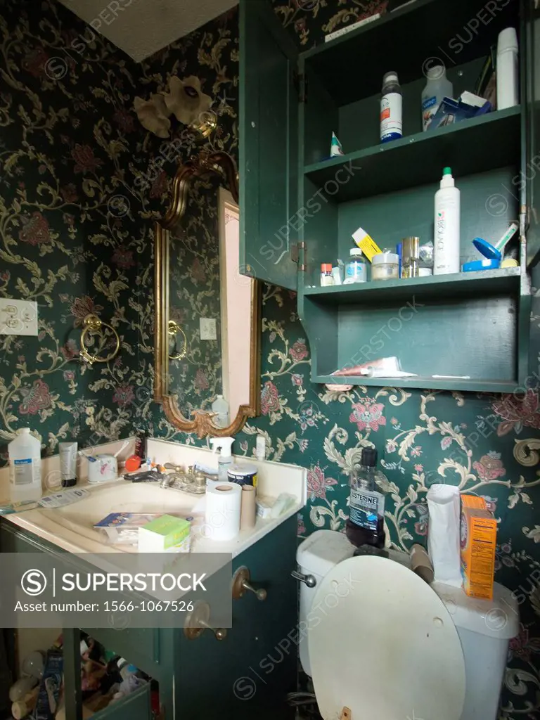 A bathroom is littered with random possessions inside a foreclosed home in LaPlace, Louisiana, United States